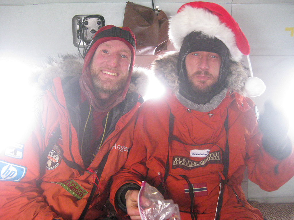 So Santa Claus left his hat at the North Pole! Keith and Sebastian, jubilant even if exhausted fill up on chocolate cookies in the helicopter on their way home.